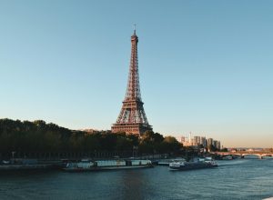 pexels-photo-2082103-2082103 Scenic view of the Eiffel Tower and Seine River at sunset, showcasing iconic Parisian architecture.